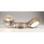 A PAIR OF AUSTRIAN SILVER OVAL PIERCED BASINS, on four claw feet, 6ins long, stamped Wien, and a