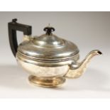A CIRCULAR TEAPOT with ebony handle and finial. Birmingham 1935. Gross weight 12ozs.
