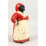 A VICTORIAN PAINTED CAST IRON MONEY BOX OF A LADY, in a red dress and scarf with white apron. 10.