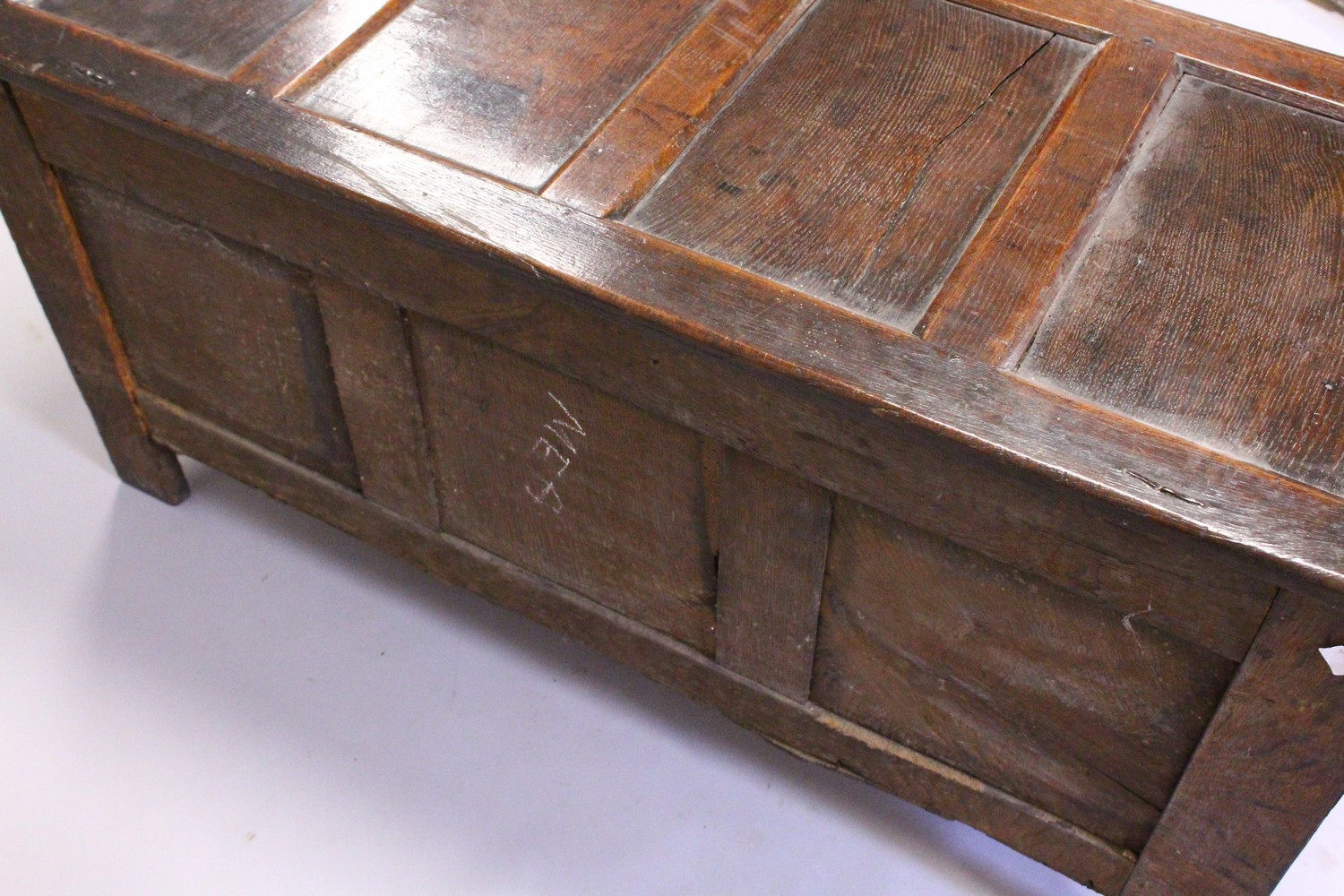 A 17TH CENTURY OAK COFFER, with a four panelled top, over a carved frieze and three carved panels, - Image 7 of 7