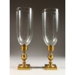 A GOOD PAIR OF REGENCY STORM LIGHTS, with large glass bowls, on gilt metal bases. 15.5ins high.