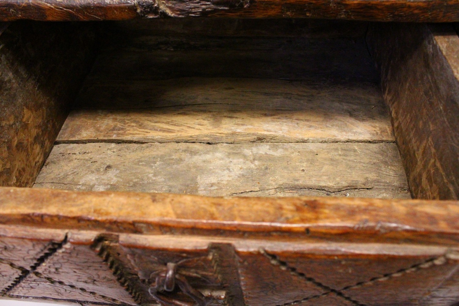 A 16TH CENTURY OAK RUSTIC LOW TABLE, with plank top over a drawer with carved decoration, a circular - Image 5 of 7