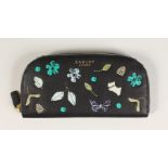 A RADLEY BLACK LEATHER PURSE with applied decoration.