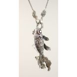 A SILVER ARTICULATED GARNET EYE FISH NECKLACE.