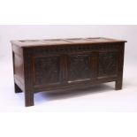 A 17TH CENTURY OAK COFFER, with a four panelled top, over a carved frieze and three carved panels,