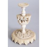 A CHINESE CARVED IVORY STAND for a ball. 4.5ins high.
