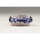 A REAL TANZANITE AND ZIRCON THREE-ROW SILVER RING.