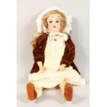 AN ARMAND MARSEILLE BISQUE HEADED DOLL, Mark A9M, long flowing hair, white bonnet and articulated