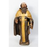 AN 18TH CENTURY ITALIAN CARVED WOOD, PAINTED AND GILDED STANDING PRIEST holding a bible. 24ins