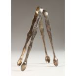 TWO PAIRS OF GEORGIAN BRIGHT CUT SUGAR TONGS. London Circa. 1785 and Newcastle Circa. 1785 (2).