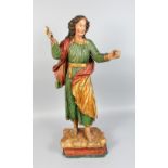 AN 18TH CENTURY CARVED AND PAINTED FIGURE OF A GIRL in flowing robe, her arms outstretched. 31ins