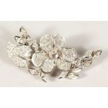 AN 18CT WHITE GOLD FLOWER SHAPED DIAMOND BROOCH.