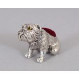 A SILVER BULLDOG PIN CUSHION.