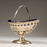 A GOOD GEORGE III PIERCED AND ENGRAVED BOAT SHAPED SUGAR BASIN, with swing handle and blue liner.