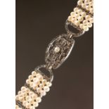 A FIVE-ROW PEARL AND MARCASITE SILVER BRACELET.