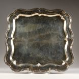 A SQUARE SHAPED PLAIN SALVER, 11.5ins wide, on four bracket feet. London 1902. Makers: