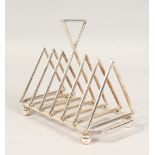 A CHRISTOPHER DRESSER DESIGN SIX DIVISION TRIANGULAR TOAST RACK, on four bun feet. 6.5ins long.