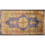 A GOOD KIRMAN PART SILK CARPET, pale blue ground, with stylised floral medallions, within a