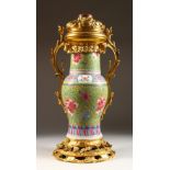 A GOOD 19TH CENTURY CHINESE FAMILLE ROSE GILT MOUNTED BRONZE VASE, QING DYNASTY, the baluster vase