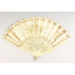 A FRENCH IVORY AND PAPER FAN, painted with gilt decoration. 17ins open.