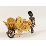 A BRONZE FIGURE OF A YOUNG GIRL, pushing a sleigh. 13ins long.