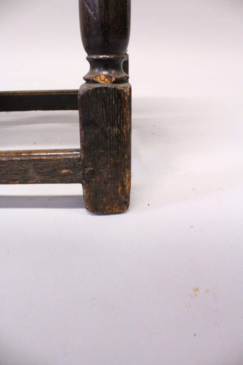 A 17TH/18TH CENTURY OAK JOINT STOOL, with plank top, carved with a male figure, fluted carved - Image 3 of 3