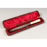A VICTORIAN ENGRAVED CARVING KNIFE with mother-of-pearl handle in a fitted case. Sheffield 1898.