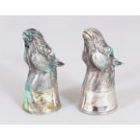A GOOD PAIR OF CAST SILVER HORSE HEAD SALT AND PEPPERS.