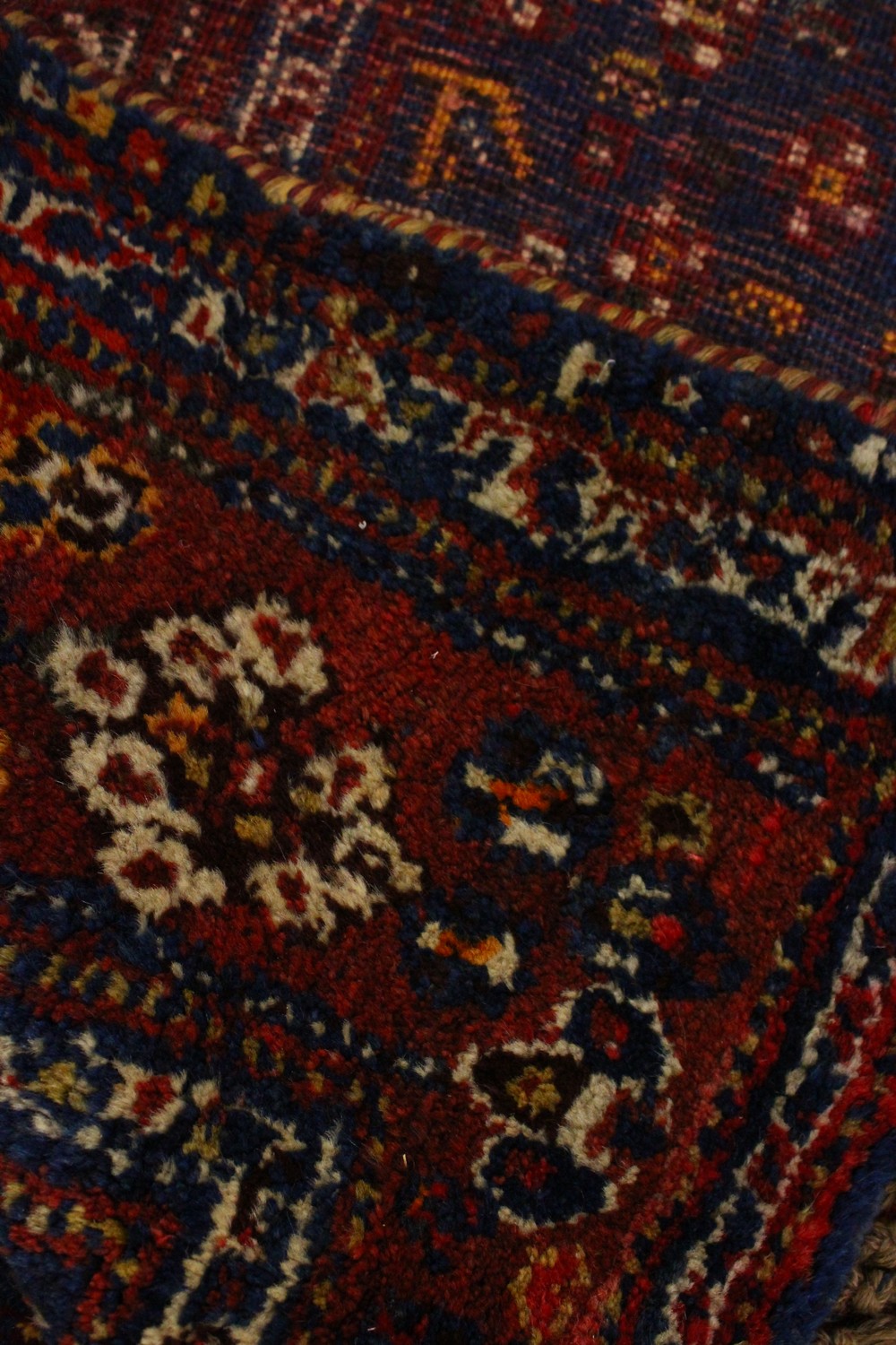 A PERSIAN CARPET, blue and red ground, decorated with stylised motifs. 8ft 3ins x 5ft 3ins. - Image 2 of 4