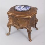 A SMALL BRONZE JEWELLERY BOX, the lid with a circular enamel. 3.5ins high.
