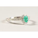 AN 18CT WHITE GOLD, EMERALD AND DIAMOND SET PEAR SHAPED CLUSTER RING of 1ct approx.