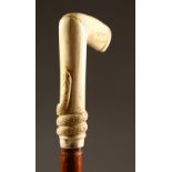 A BONE HANDLED WALKING STICK. carved with a snake. 39ins long.