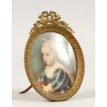 AN OVAL MINIATURE OF A CHILD. 3ins x 2.5ins, in a gilt metal frame.