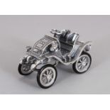 A NOVELTY SILVER MINIATURE VINTAGE CAR.