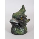 A COLD PAINTED PARAKEET INKWELL, with glass eyes. 3ins high.