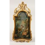A LATE 18TH CENTURY FRENCH CARVED IVORY FRAMED EASEL PICTURE, the frame with crest and pierced