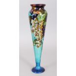 A LIMOGES ENAMEL VASE, of tapering form, decorated with fruiting vines. 11ins high.