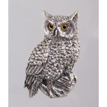 A SILVER AND MARCASITE OWL BROOCH.
