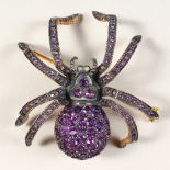 A 9CT GOLD, AMETHYST AND DIAMOND SET SPIDER BROOCH.