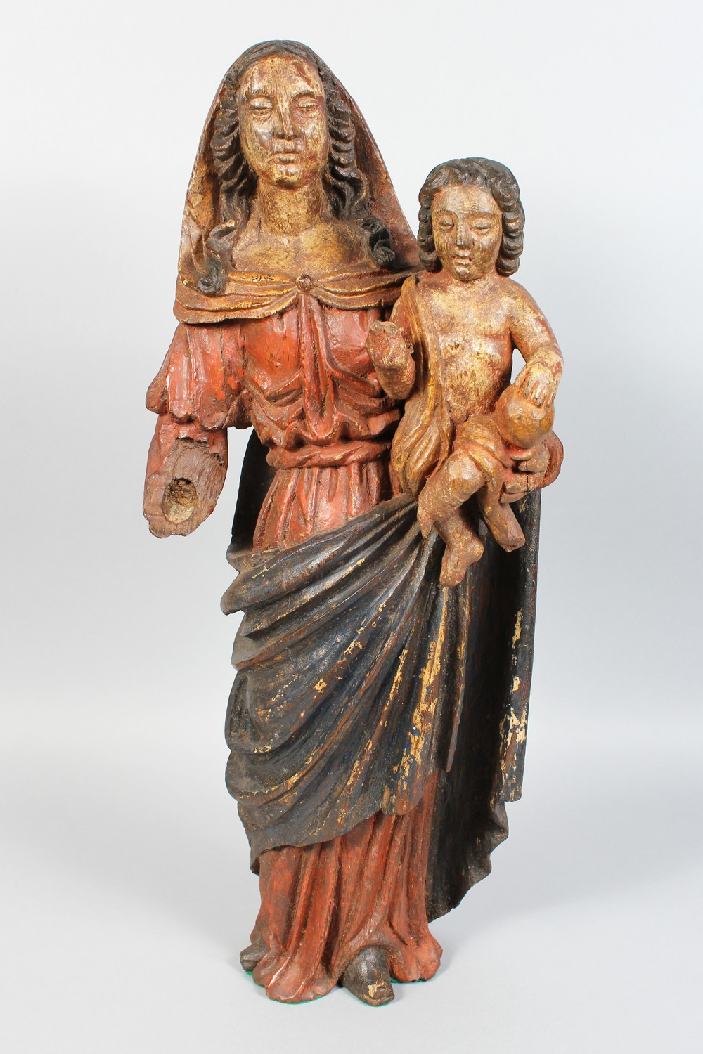 AN 18TH CENTURY CARVED AND PAINTED GROUP, Madonna and Child, hand missing. 24ins high.