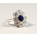 A FAUX SAPPHIRE AND ZIRCON SILVER RING.