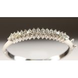 A VERY GOOD WHITE GOLD DIAMOND HINGED BANGLE of 5.8cts.