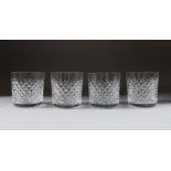 A SET OF FOUR WATERFORD HOBNAIL CUT WHISKY TUMBLERS.