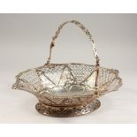 A GEORGE III OVAL PIERCED CAKE BASKET, with swing handle, crested. London 1766. Maker: S.