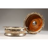 A GOOD PAIR OF GEORGE III CIRCULAR WINE COASTERS with shell and scroll border. 6ins diameter, 1809.