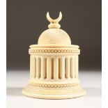 AN ISLAMIC CARVED IVORY CIRCULAR BOX AND COVER, with pierced column sides. 4.25ins high.
