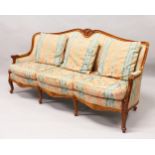 A MODERN FRENCH STYLE THREE-SEATER SETTEE, with carved show wood frame, upholstered with a classical