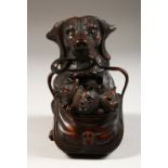 A CARVED BLACK FOREST INKWELL DOG WITH PUPPIES, in a basket. 5ins high.