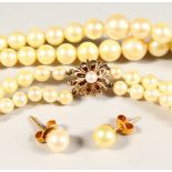 A TWO-ROW PEARL NECKLACE AND EAR STUDS.