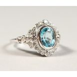 A BLUE TOPAZ AND ZIRCON CLUSTER RING, in silver.